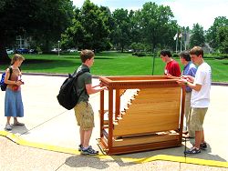 Students carrying
          small Rathke organ outside